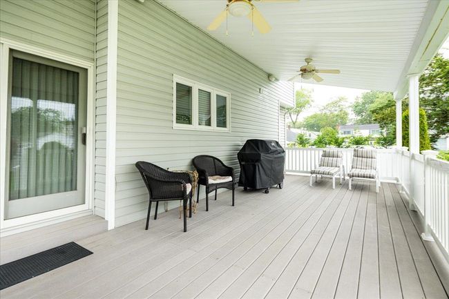 Deck featuring a ceiling fan and grilling area | Image 30