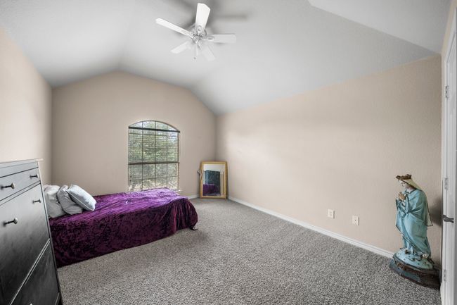 Bedroom with carpet floors, baseboards, lofted ceiling, and ceiling fan | Image 28