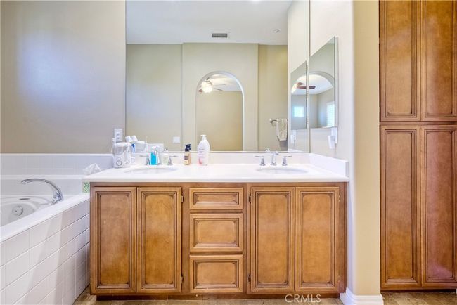 Primary ensuite bath offers extra wall of cabinetry, always so welcome to have extra storage spots | Image 29