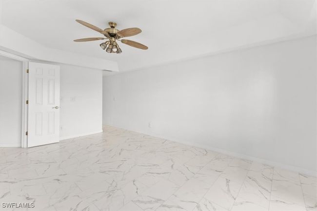 Spare room with ceiling fan and light tile patterned floors | Image 19