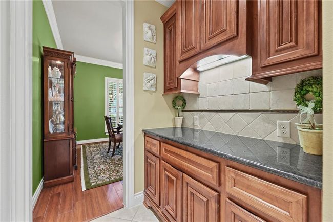 Well appointed Butler's Pantry with under cabinet lighting provides ample space to prepare refreshments or setup the coffee bar you have always wanted. | Image 10