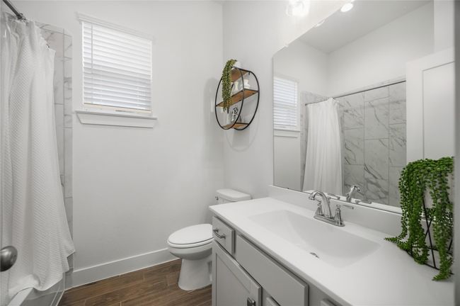This stylish secondary bath offers an extended vanity and sleek finishes, making it as functional as it is beautiful for guests or daily use. | Image 24