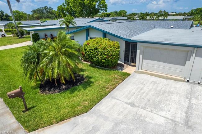 Ranch-style house with an attached garage, driveway, a front yard, a shingled roof, and stucco siding | Image 34