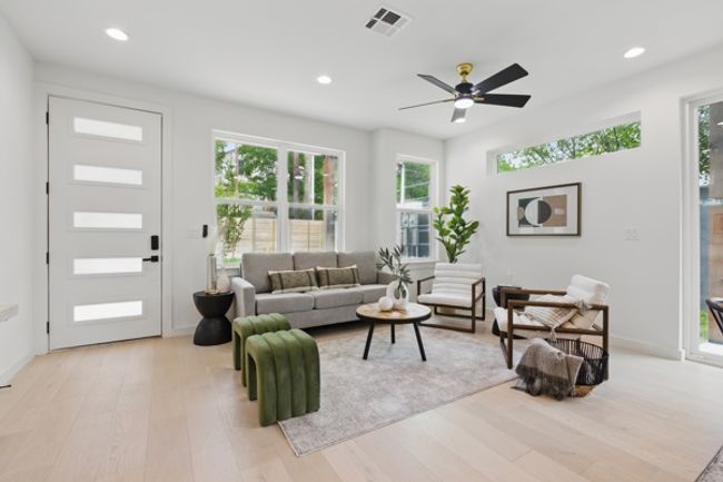 Living area with a ceiling fan, visible vents, recessed lighting, and light wood-type flooring | Image 5
