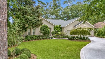 View of front of house with a garage and a front lawn | Image 1