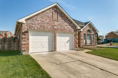 View of property featuring a front yard and a garage | Image 2