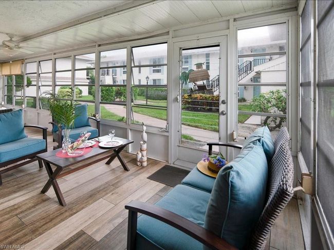 Sunroom with a ceiling fan and view | Image 16