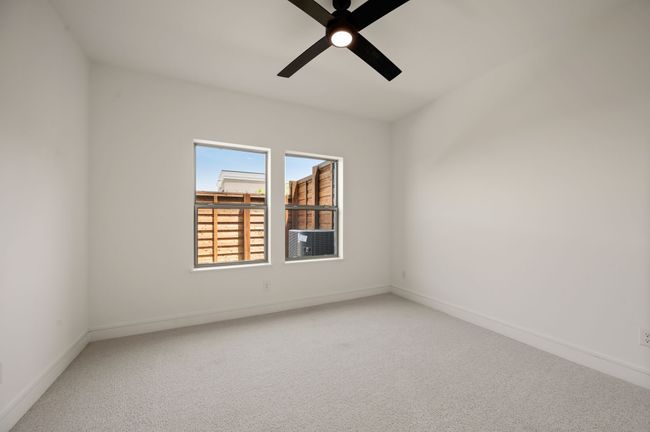 Your guests will enjoy this spacious, main level secondary bedroom with adjacent bath. | Image 7