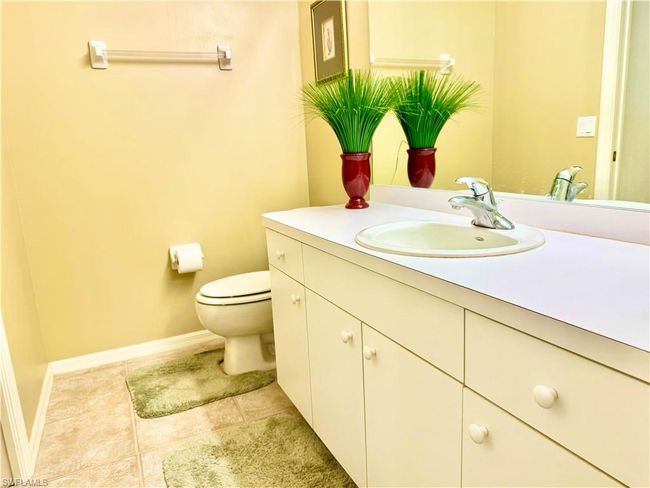 Bathroom with tile patterned flooring, toilet, vanity, and baseboards | Image 20