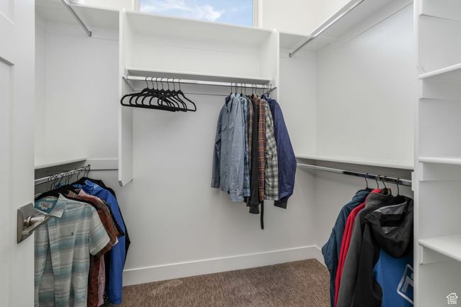 Bright and airy primary walk-in closet featuring abundant natural light. | Image 16
