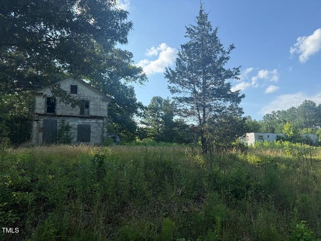 view from road facing uninhabitable home | Image 8
