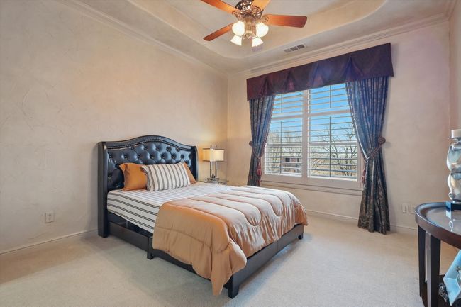 This main floor guest suite has an ensuite bath and a view of the golf course. | Image 24