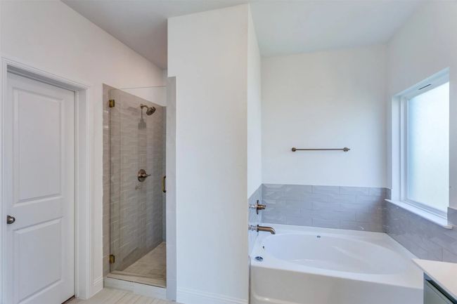 Bathroom featuring vanity and independent shower and bath | Image 13