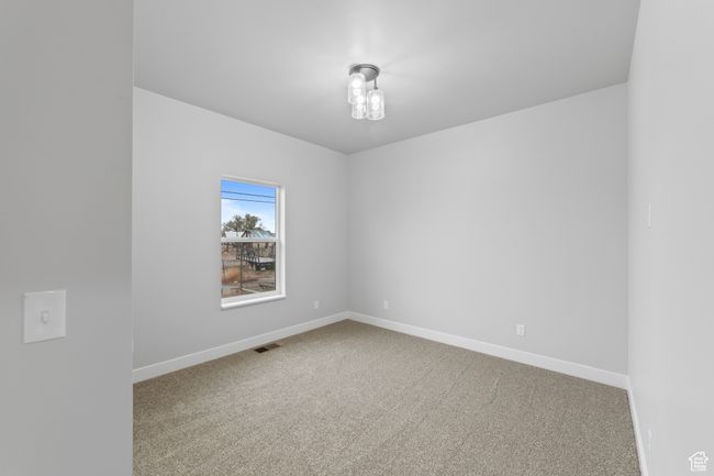 Carpeted spare room with baseboards and visible vents | Image 21