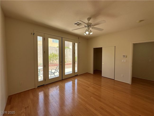 Unfurnished bedroom featuring french doors, access to exterior, light wood-type flooring, a ceiling fan, and baseboards | Image 16