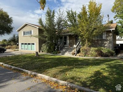 Obstructed view of property with a garage and a front yard | Image 2