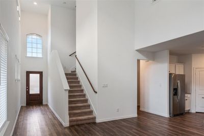 Foyer entrance with dark hardwood / wood-style flooring and a towering ceiling | Image 3