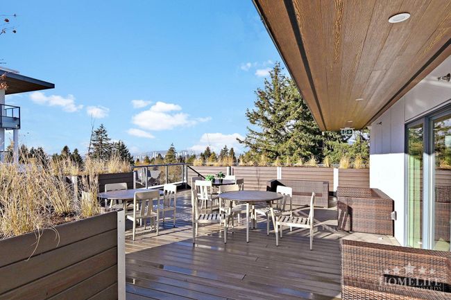 Wooden deck featuring outdoor dining area | Image 19