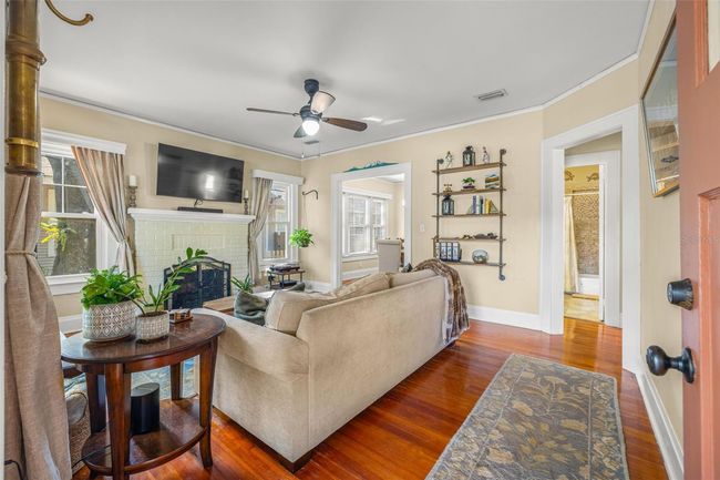 Original hardwood floors, fireplace and lots of natural light. | Image 7