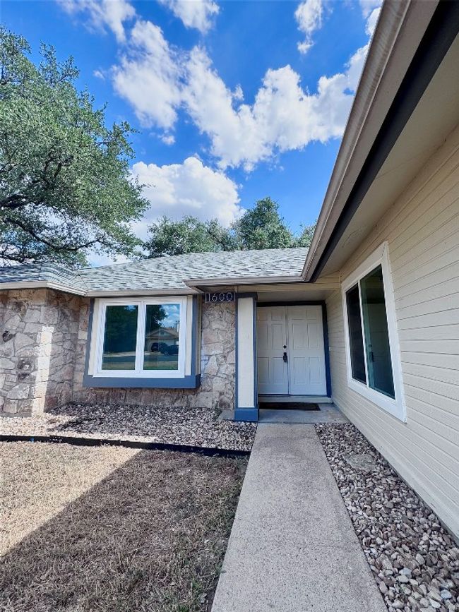Property entrance featuring stone siding and a shingled roof | Image 4