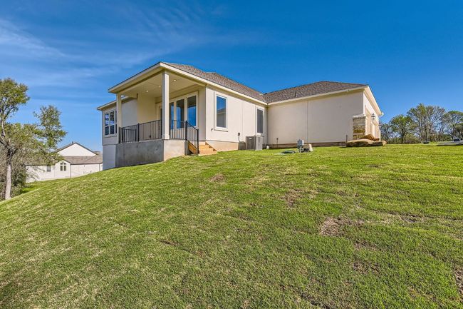Rear view of property featuring a yard, central AC, and stucco siding | Image 26