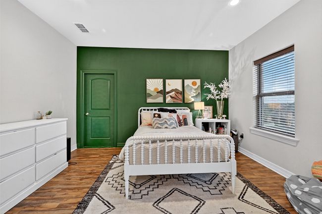 Bedroom featuring an accent wall, wood finished floors, and recessed lighting | Image 27
