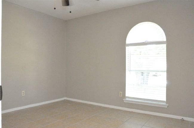 Unfurnished room with light tile patterned floors, a healthy amount of sunlight, a ceiling fan, and baseboards | Image 21