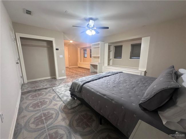 Bedroom featuring ceiling fan and a closet | Image 10