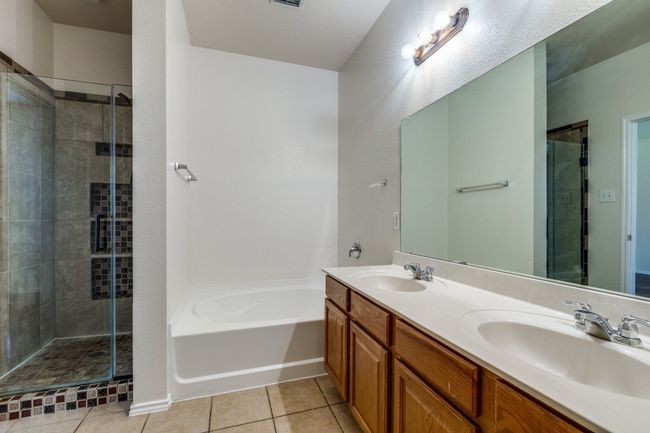 Full bathroom with a sink, a bath, a shower stall, and tile patterned flooring | Image 22