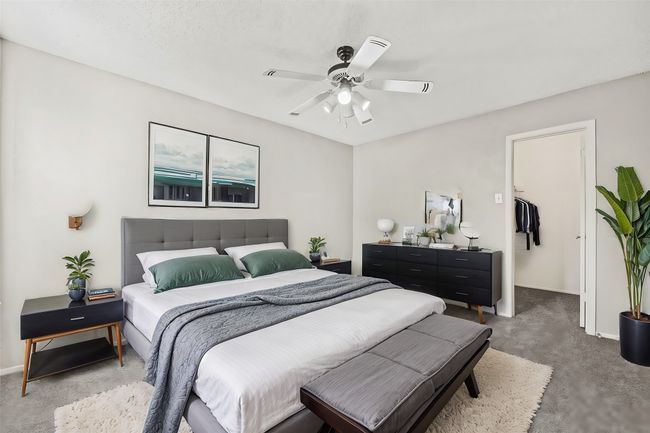 Bedroom featuring a spacious closet, carpet floors, and baseboards | Image 7