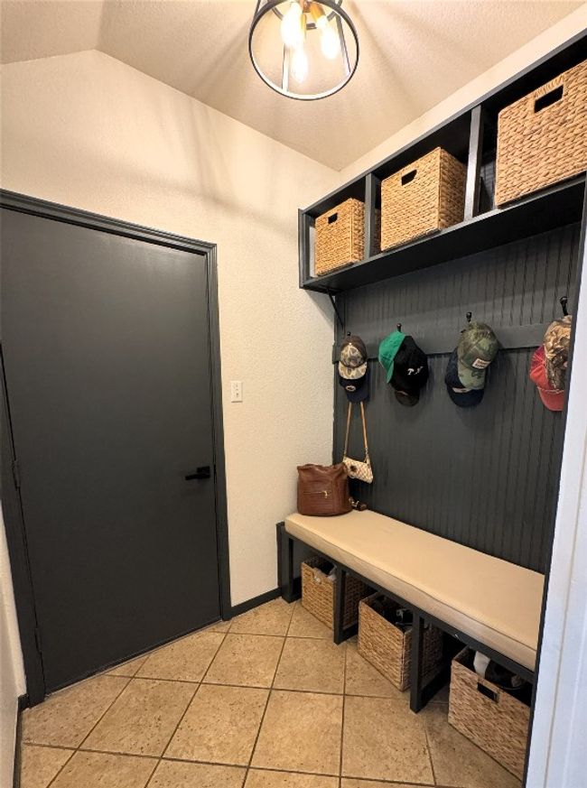 Mudroom featuring a textured ceiling, and light tile patterned flooring. | Image 12