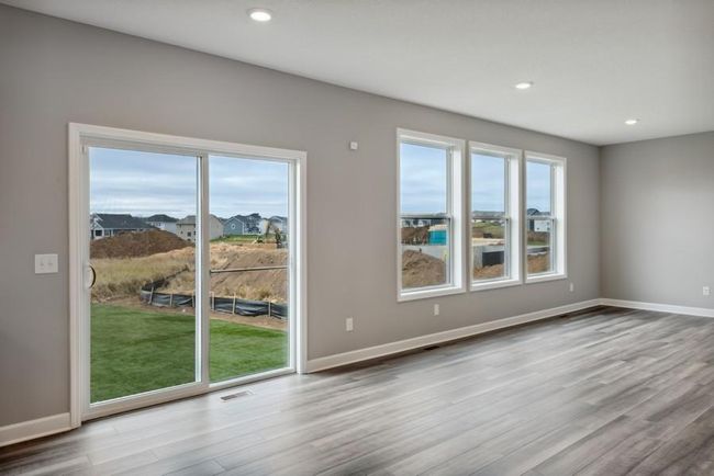 (Photo is of an inventory home, actual homes finishes will vary) Soaked in natural sunlight, the homes eat-in dining room has ample space for a dining table located in the heart of the home. | Image 4