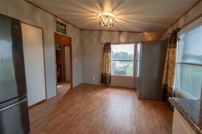 Spare room featuring light hardwood / wood-style floors and crown molding | Image 23