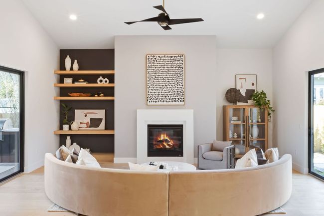 Living room featuring light wood finished floors, baseboards, recessed lighting, a glass covered fireplace, and a ceiling fan | Image 21