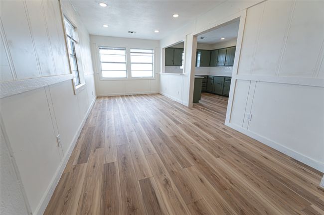 Spare room featuring a decorative wall, recessed lighting, and light wood-type flooring | Image 9