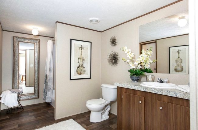 Full bathroom with vanity, wood finished floors, ornamental molding, a textured ceiling, and toilet | Image 9