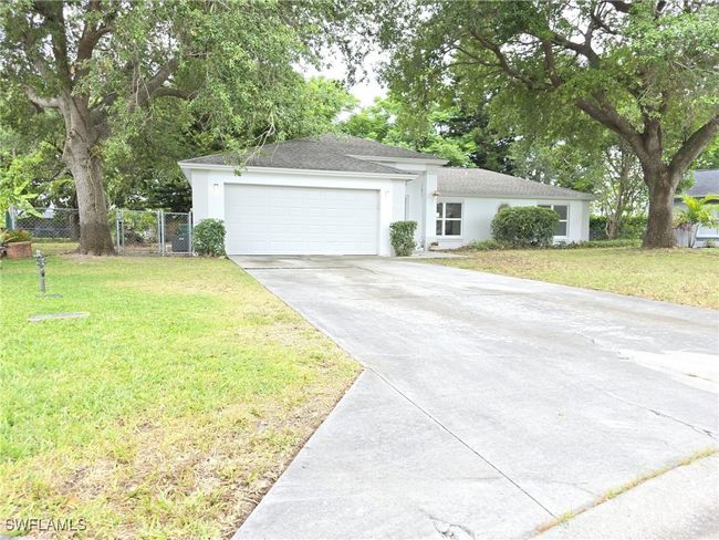 Ranch-style home with concrete driveway, a garage, stucco siding, and a shingled roof | Image 41