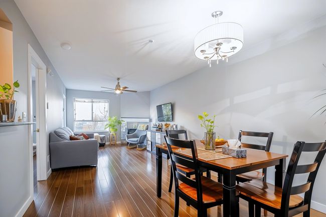 Dining room featuring dark wood-type flooring, baseboards, and a ceiling fan | Image 10