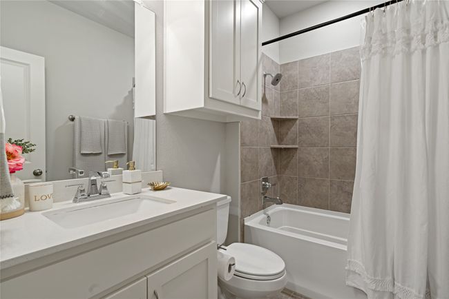 Full bathroom featuring vanity, toilet, and shower / bathtub combination with curtain | Image 17