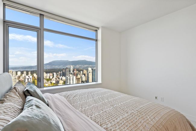 Bedroom featuring a mountain view and multiple windows | Image 21