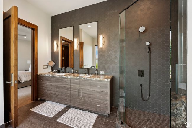 Full bathroom featuring a shower stall, double vanity, and ensuite bath | Image 84