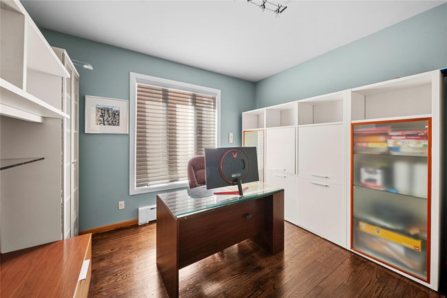 Home office featuring a baseboard heating unit, dark wood-style flooring, and baseboards | Image 12