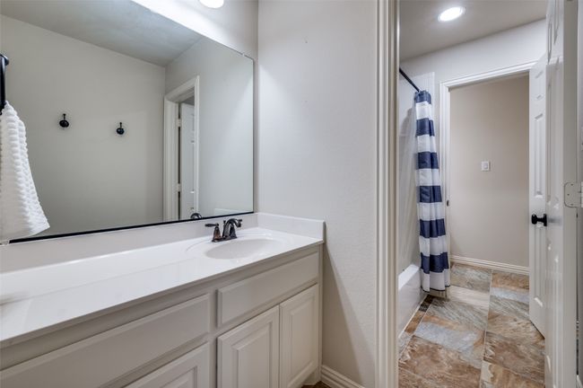 The first-floor ensuite bath features a large vanity for ample storage and a walk-in shower, combining both function and style. | Image 25
