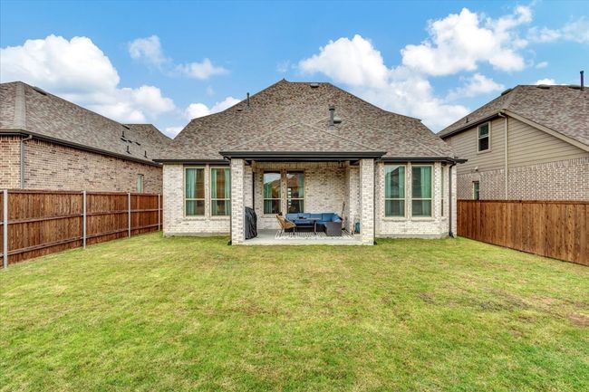 Covered patio for your barbeque and outside meals. Lots of open space in the backyard. | Image 21