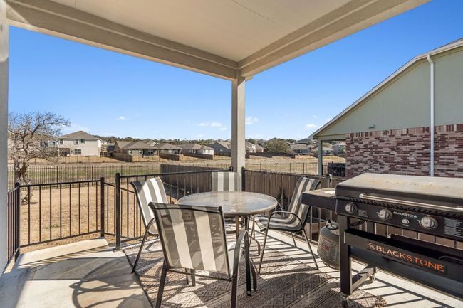 View of patio featuring outdoor dining space, a residential view, fence, and area for grilling | Image 29