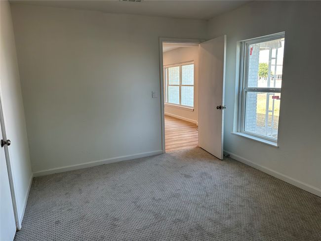 Unfurnished room featuring carpet floors, a wealth of natural light, baseboards, and visible vents | Image 17