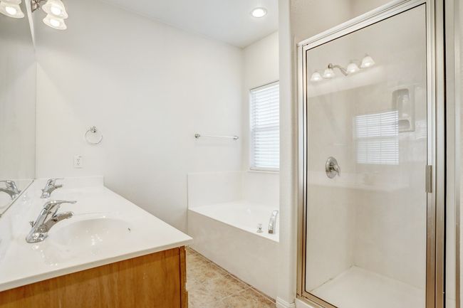 Full bathroom with a stall shower, a garden tub, double vanity, tile patterned flooring, and recessed lighting | Image 12
