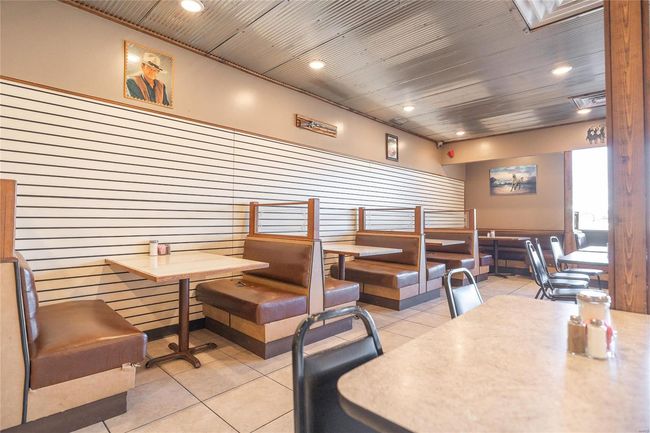 Dining room featuring light tile patterned floors and metal ceiling | Image 8