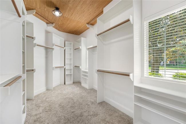 Designed with both luxury and lifestyle in mind, the custom primary Elfa closet offers boutique-level organization with built-ins, double-height hanging space, and soft lighting. It’s not just a closet — it’s a dressing experience. Every detail was considered to make mornings smoother and evenings more indulgent. | Image 33