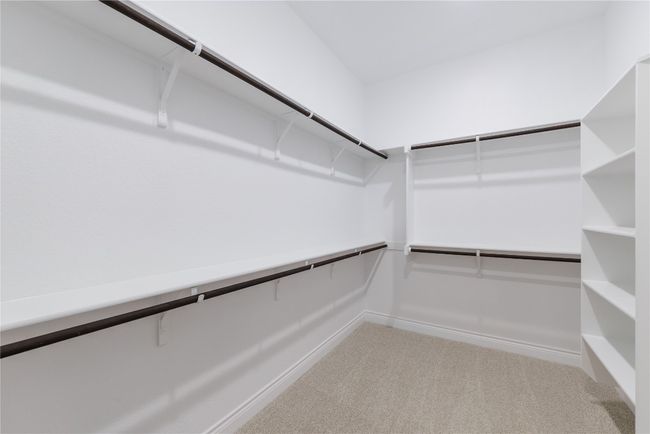 Spacious closet with light colored carpet | Image 32